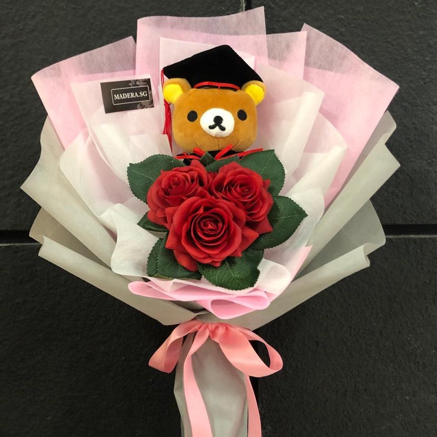 Graduation Rilakumma Bear (16cm) Hug 3 Artificial Red Roses in pink/grey wrap